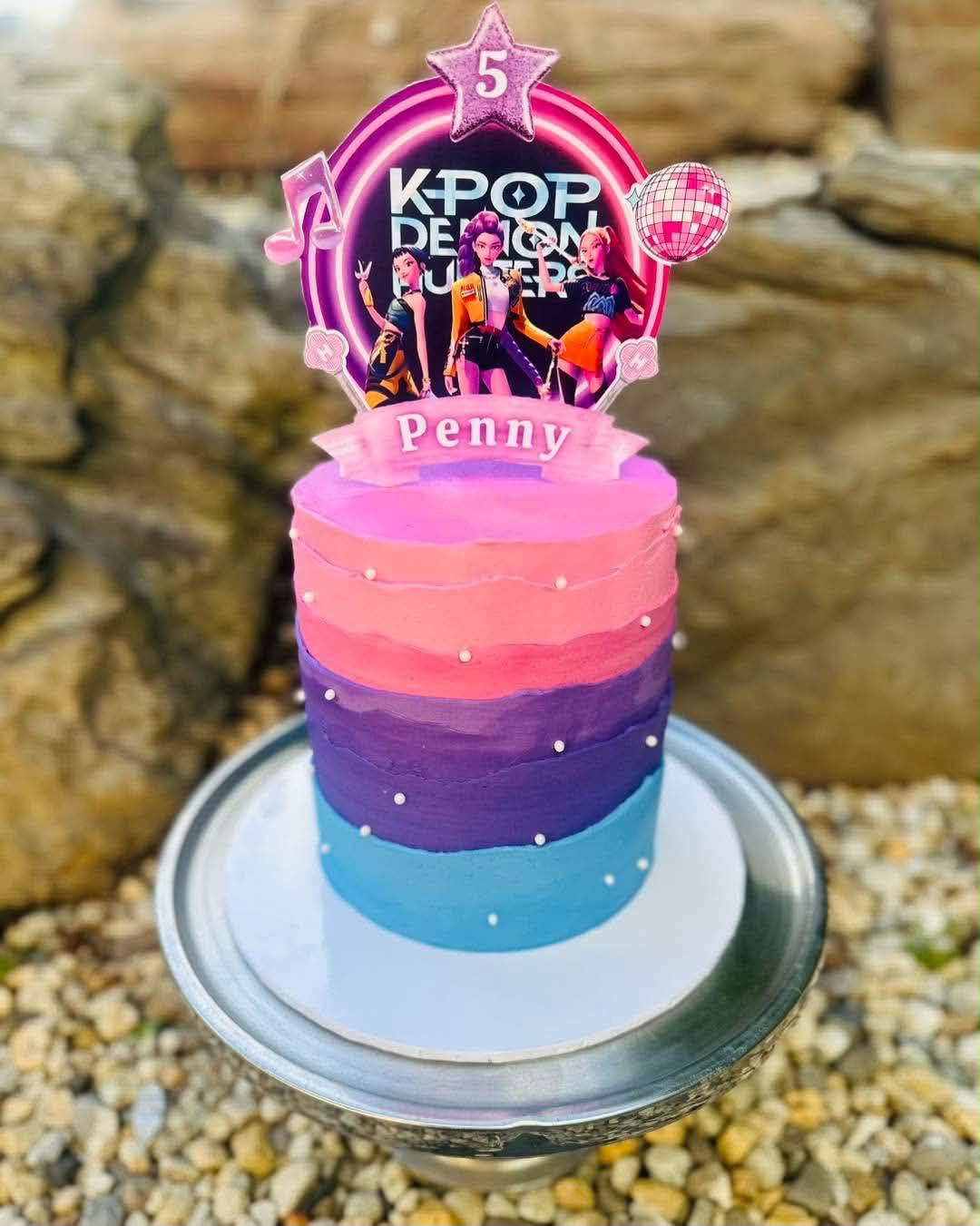 Pink, purple and blue ombre birthday cake for Penny's 5th with K-Pop Demon Hunters topper