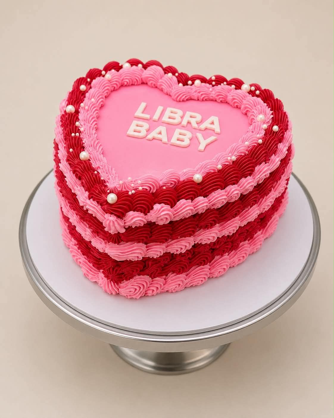 Orange and pink heart cake with fresh cherries on top