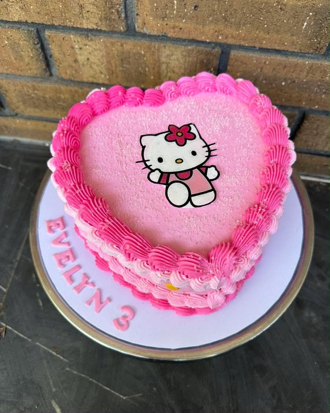 Pink and black Bratz doll edible print heart cake front view with silver cherries