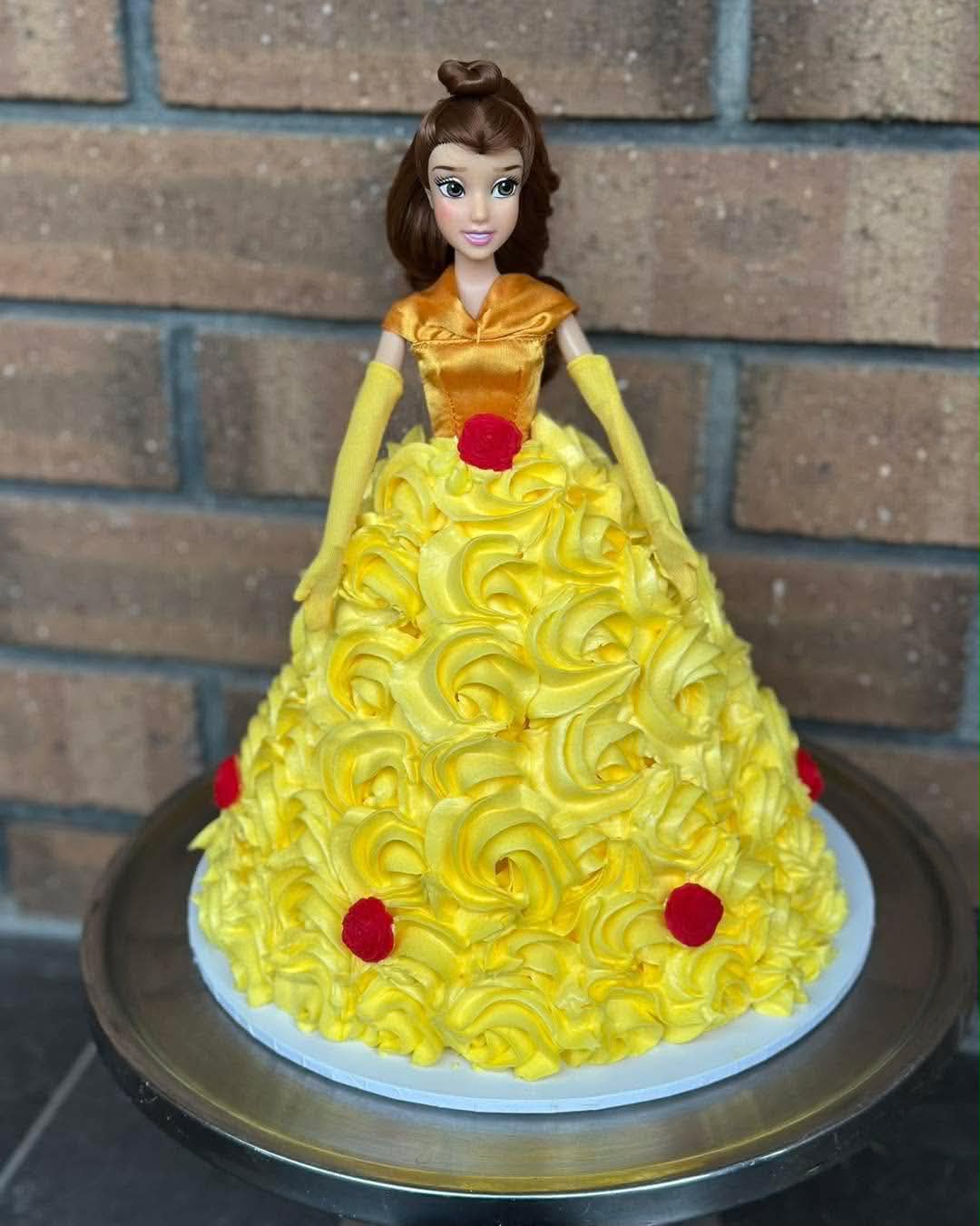 Belle Beauty and the Beast doll cake with yellow buttercream rosette dress and red rose accents