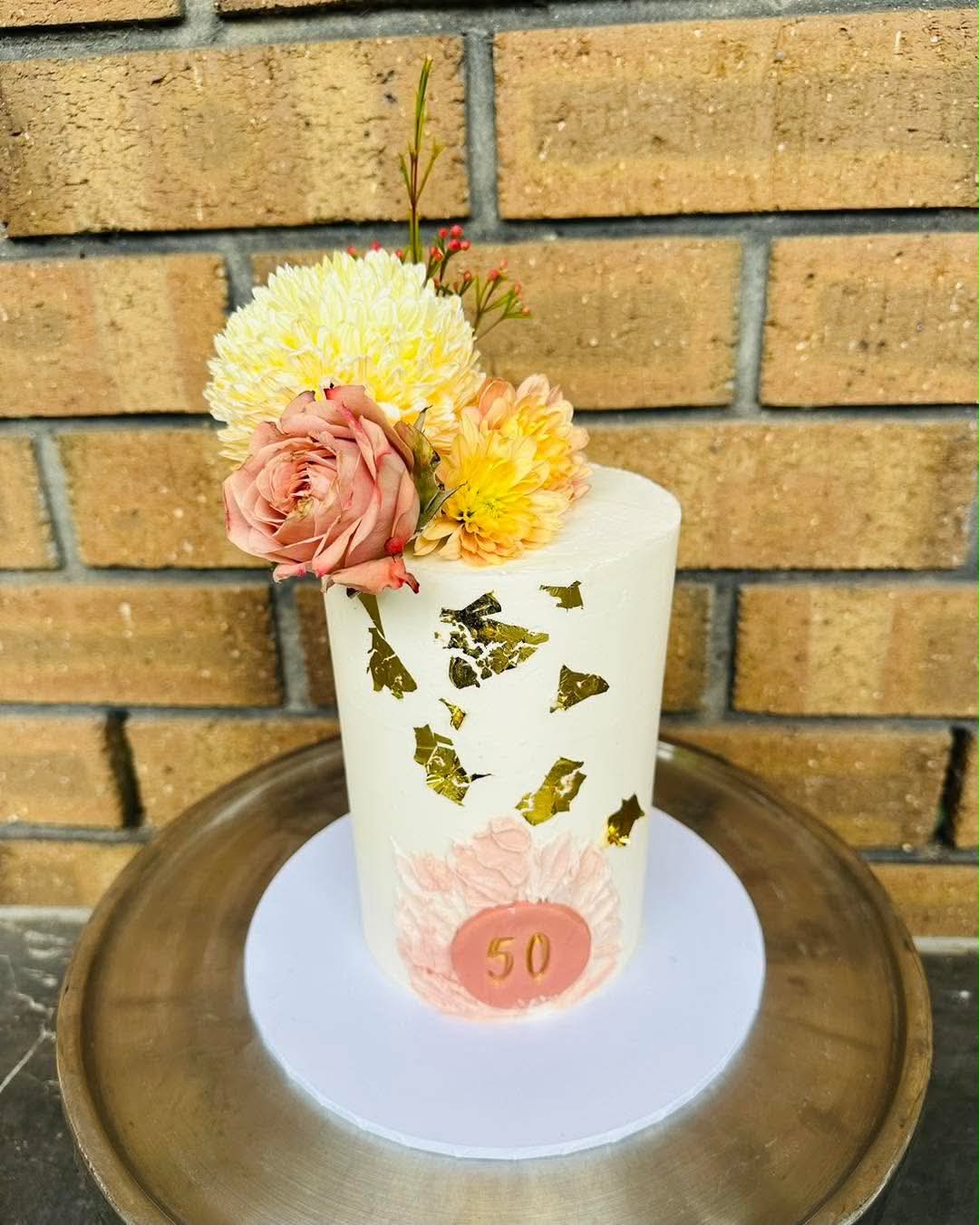 Two-tier purple and yellow LA Lakers birthday cake with personalised face edible print, gold crown, basketball hoop topper and number 23 jersey topper
