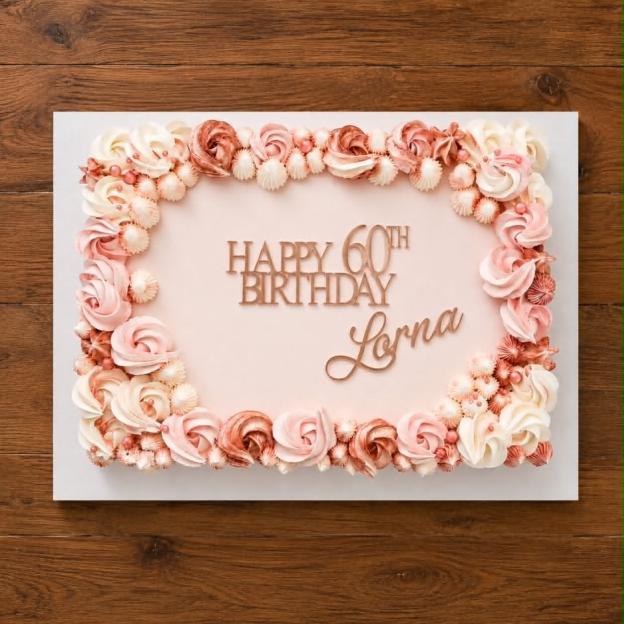 White slab cake with pink and rose gold buttercream rosette and shell border and Happy 60th Birthday Lorna acrylic topper