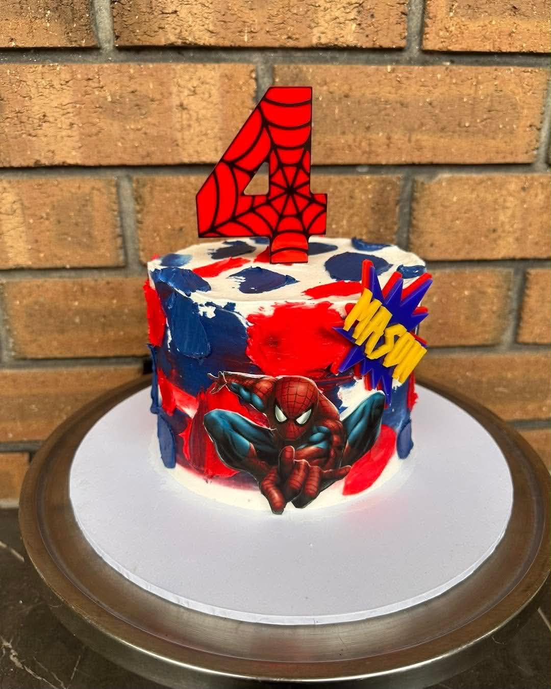 Spiderman birthday cake for Mason's 4th with red and blue brushstroke buttercream and Spiderman figurine